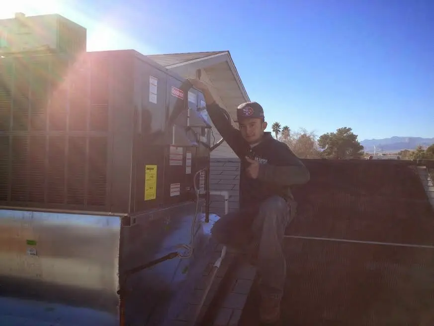 HVAC technician performing AC Tune-Up on a rooftop unit in El Segundo